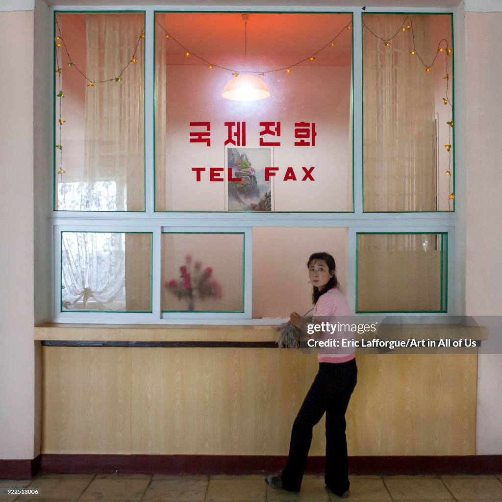 North Korean woman in front of a telephone and fax corner in an hotel, South Hamgyong Province, Hamhung, North Korea...