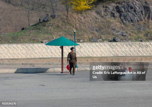 Soldier under umbrella at a checkpoint on a highway, Pyongan Province, Pyongyang, North Korea on April 13, 2008 in Pyongyang, North Korea.