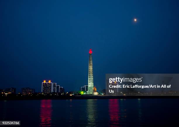 Juche tower with red flame in front of the Taedong river at night, Pyongan Province, Pyongyang, North Korea on September 9, 2011 in Pyongyang, North...