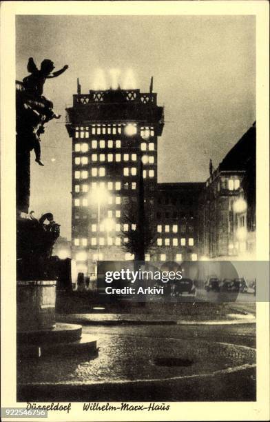 Ak Düsseldorf, Wilhelm Marx Haus bei Nacht, Regen