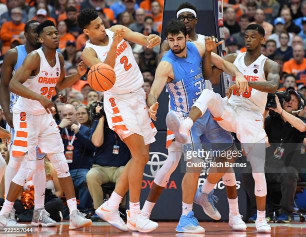 Matthew Moyer of the Syracuse Orange, Luke Maye of the North Carolina Tar Heels and Frank Howard of the Syracuse Orange react to a loose ball during...