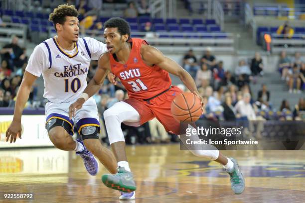Southern Methodist Mustangs guard Jimmy Whitt drives around East Carolina Pirates guard Aaron Jackson during a game between the Southern Methodist...