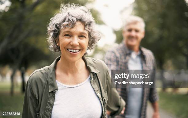 i’ll go anywhere as long as we’re together - happy senior couple walking stock pictures, royalty-free photos & images