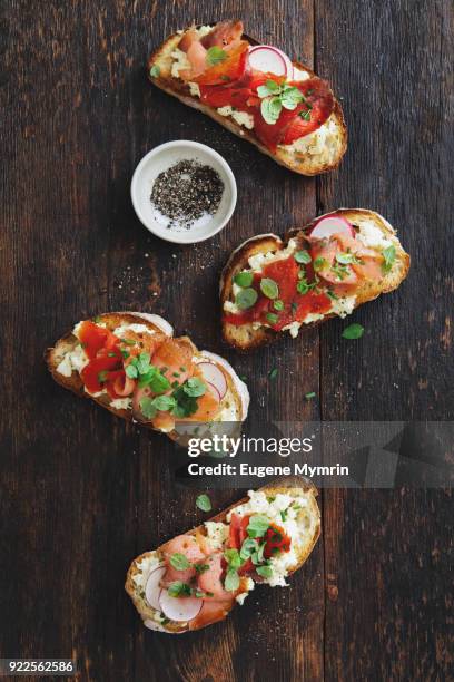 bruschetta with smoked trout and mascarpone scrambled eggs - trout stock photos et images de collection