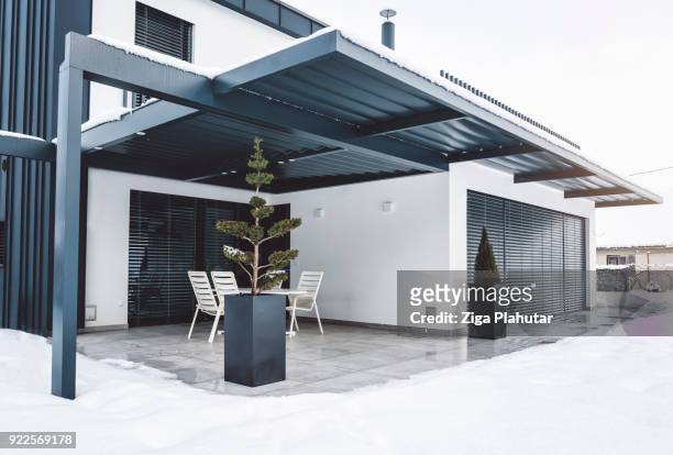 pergola haut toit dur comme élément clé de cette villa moderne - cloture maison photos et images de collection