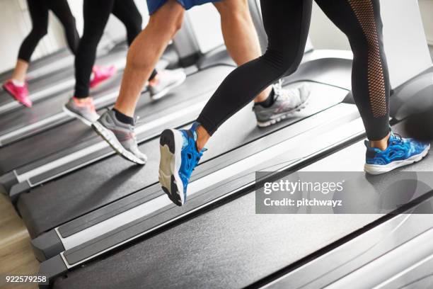 unrecognized people running on treadmill. - running spikes stock pictures, royalty-free photos & images