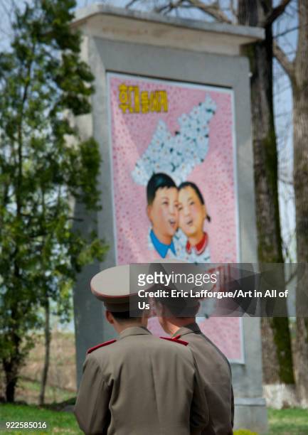 North Korean soldiers in the Demilitarized Zone in front of a propaganda billboard for the reunification, North Hwanghae Province, Panmunjom, North...