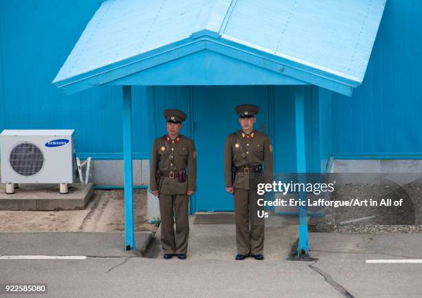 North Korean soldiers standing in front of the United Nations conference rooms on the demarcation line in the Demilitarized Zone, North Hwanghae...