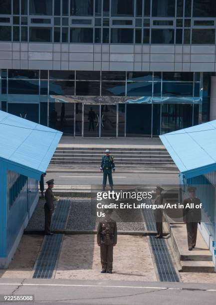 North Korean and south Korean soldiers standing in front of the United Nations conference rooms on the demarcation line in the Demilitarized Zone,...