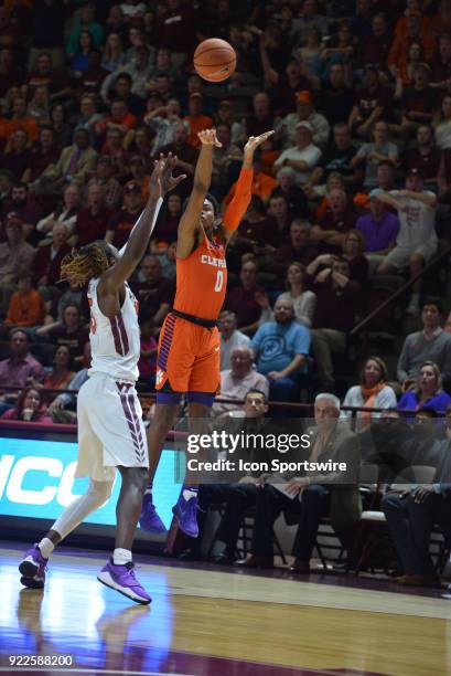 Clemson Tigers guard Clyde Trapp shoots a shot while being defended by Virginia Tech Hokies forward Chris Clarke during a college basketball game on...