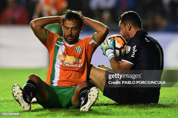 Argentina's Banfield midfielder Jesus Datolo gestures as Uruguay's Nacional goalkeeper Esteban Conde kisses the ball during their Copa Libertadores...