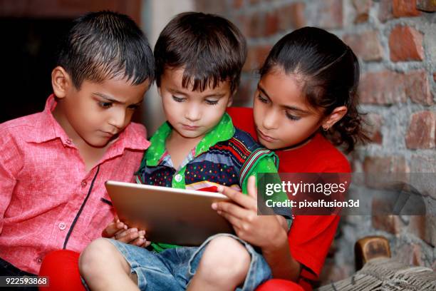 small group of children using digital tablet - graphics tablet stock pictures, royalty-free photos & images