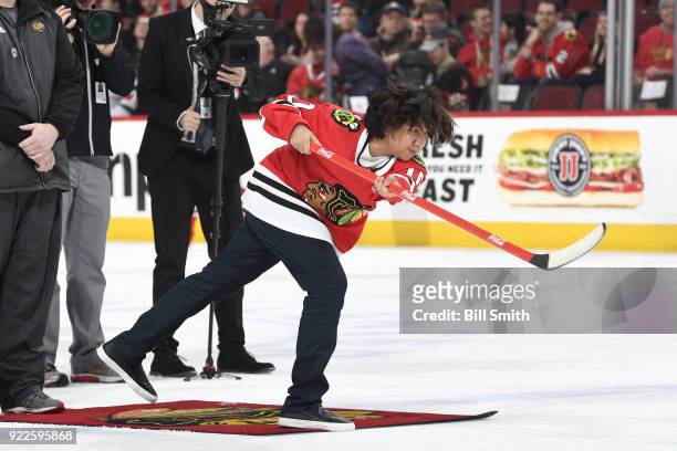 Actor Anthony Gonzalez shoots the puck in between periods of the game between the Chicago Blackhawks and the Ottawa Senators at the United Center on...