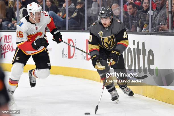 Ryan Carpenter of the Vegas Golden Knights skates with the puck while Michael Stone of the Calgary Flames defends during the game at T-Mobile Arena...