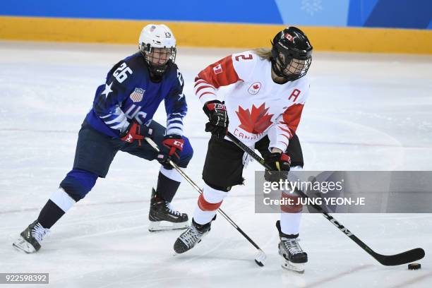 S Kendall Coyne and USA's Lee Stecklein fight for the puck in the women's gold medal ice hockey match between the US and Canada during the...