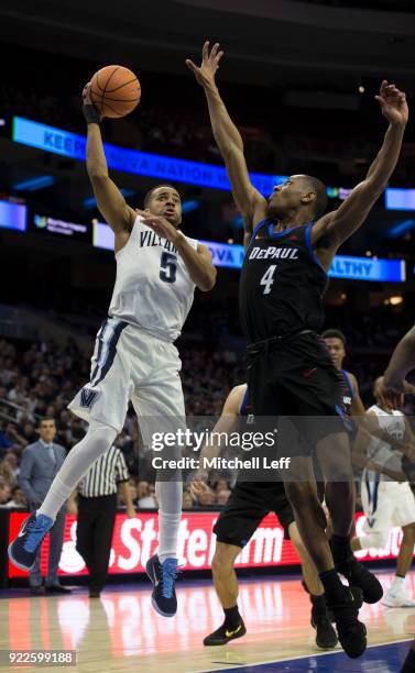 Phil Booth of the Villanova Wildcats goes up for a shot against Brandon Cyrus of the DePaul Blue Demons in the second half at the Wells Fargo Center...