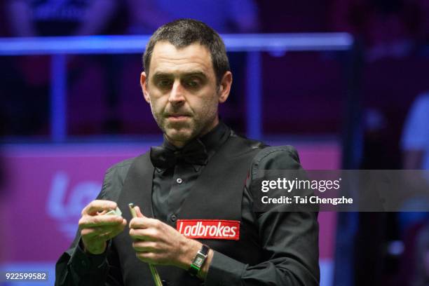 Ronnie O'Sullivan of England chalks the cue during his second round match against Yan Bingtao of China on day three of 2018 Ladbrokes World Grand...