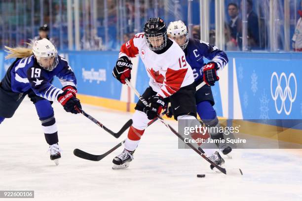 Melodie Daoust of Canada skates against Gigi Marvin of the United States in the first period during the Women's Gold Medal Game on day thirteen of...