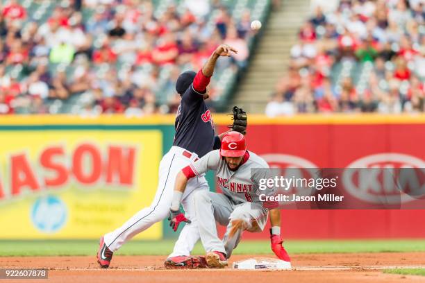 Second baseman Jose Ramirez of the Cleveland Indians throws out Zack Cozart at first as he runs into Billy Hamilton of the Cincinnati Reds for a...