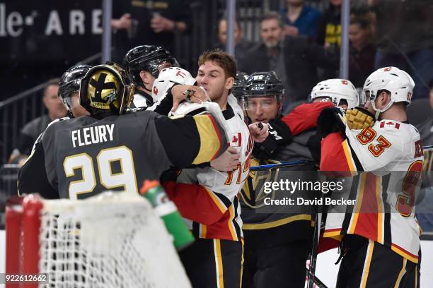 Marc-Andre Fleury and Stefan Matteau of the Vegas Golden Knights get into a scrum with Mark Jankowski and Sam Bennett of the Calgary Flames during...