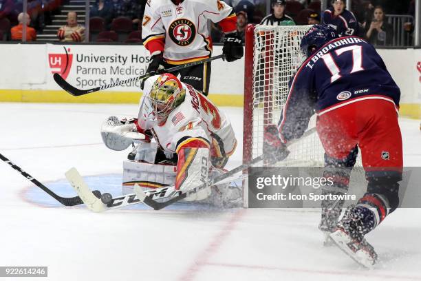 Stockton Heat goalie Mason McDonald makes a stick save against Cleveland Monsters left wing Terry Broadhurst during the second period of the American...