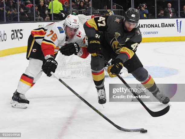 Micheal Ferland of the Calgary Flames and Luca Sbisa of the Vegas Golden Knights go after a loose puck in the first period of their game at T-Mobile...