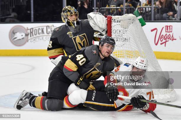 Marc-Andre Fleury and Ryan Carpenter of the Vegas Golden Knights defend their goal against Micheal Ferland of the Calgary Flames during the game at...