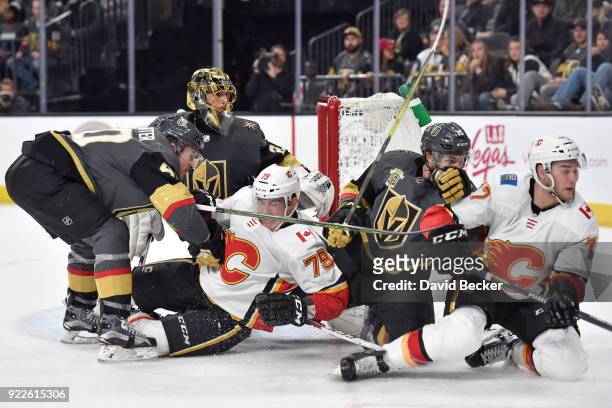 Marc-Andre Fleury defends his goal while his teammates Ryan Carpenter and Jon Merrill of the Vegas Golden Knights skate to the puck against Micheal...