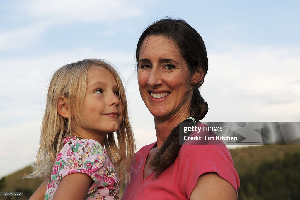 Mother holding daughter, daughter admiring mother