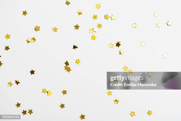 decorative golden stars on white background - gold ribbon stock pictures, royalty-free photos & images