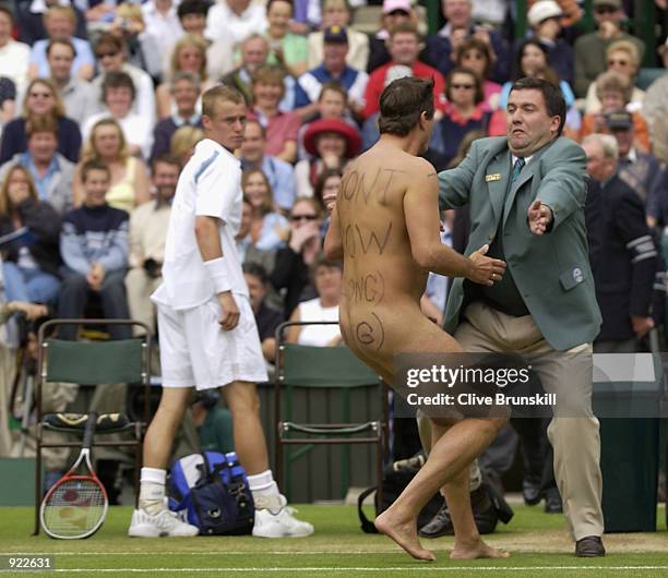 Male streaker runs onto Centre Court as Lleyton Hewitt of Australia plays David Nalbandian of Argentina during the Mens Singles Final at the All...