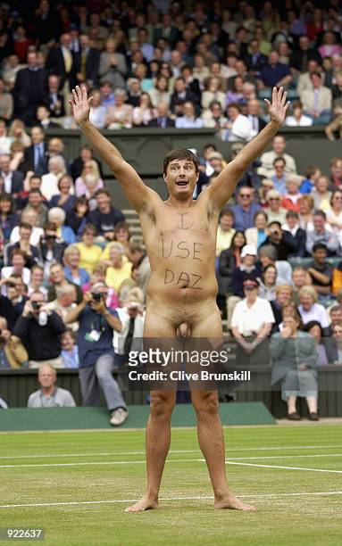 Male streaker runs onto Centre Court as Lleyton Hewitt of Australia plays David Nalbandian of Argentina during the Mens Singles Final at the All...