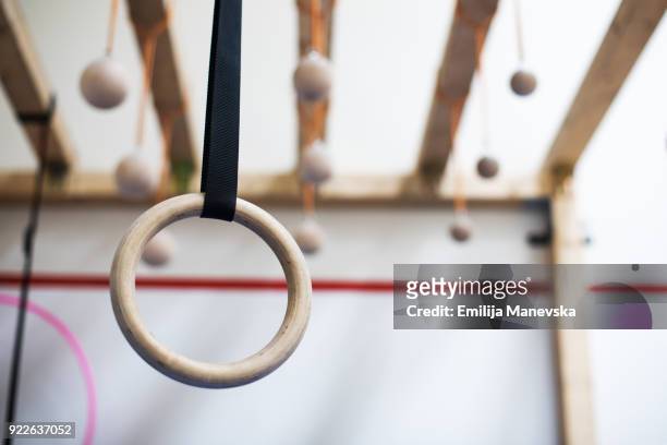 gymnastic rings in gym - gymnastics equipment stock pictures, royalty-free photos & images