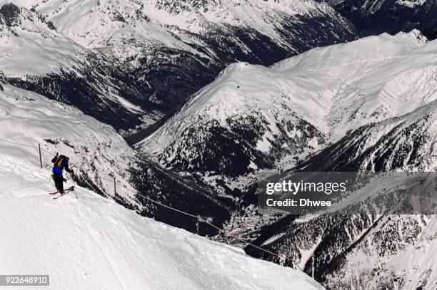 lone skier on mountain ridge against snowcapped mountains - blanche vallee stock pictures, royalty-free photos & images