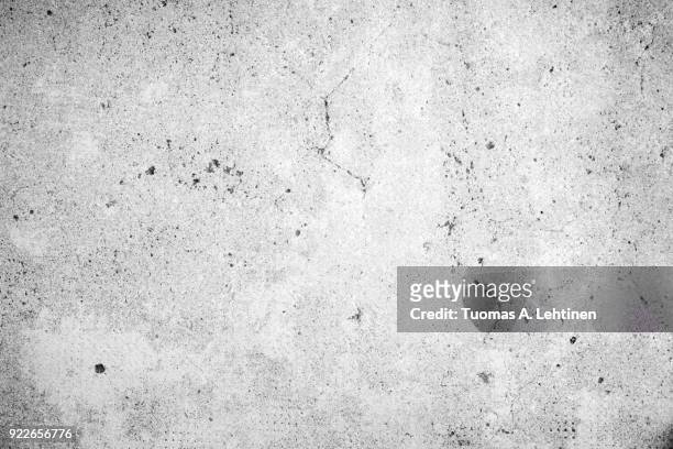 weathered and aged concrete wall texture background in black and white with vignette - verwittert stock-fotos und bilder