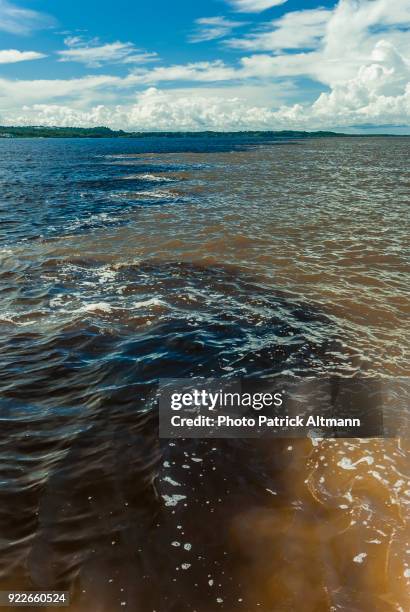 merging of the waters of two giant rivers. rio negro and rio solimões converge at manaus, amazonas, brazil - solimões river stock pictures, royalty-free photos & images