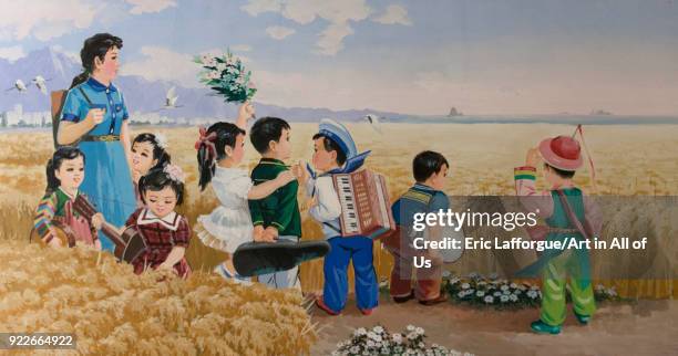 Propaganda poster depicting North Korean children in a field, Pyongan Province, Pyongyang, North Korea on May 10, 2010 in Pyongyang, North Korea.