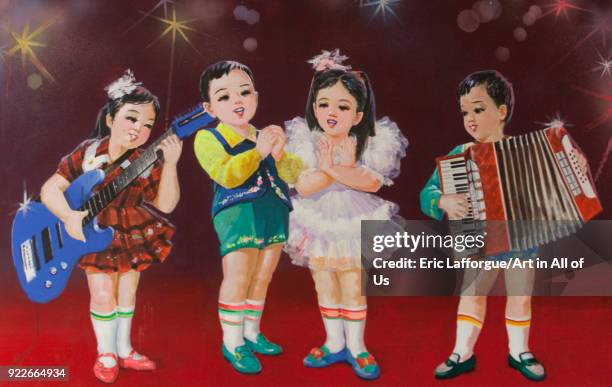 Propaganda poster depicting North Korean children playing accordion and guitar, Pyongan Province, Pyongyang, North Korea on May 10, 2010 in...