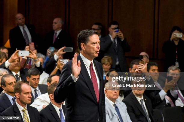 American lawyer and former FBI Director James Comey is sworn in before his testimony before the Senate Intelligence Committee, Washington DC, June 8,...