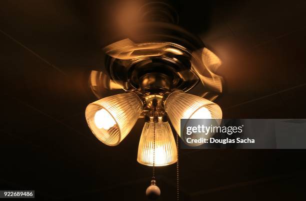 spinning ceiling fan and lights - fitting stockfoto's en -beelden