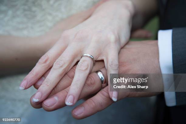bride and groom holding hands - wedding ring stock pictures, royalty-free photos & images
