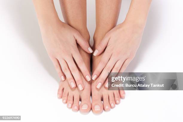 hands touching feet - pedicure stockfoto's en -beelden