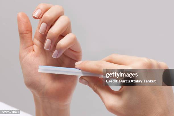 woman doing manicure - französische maniküre stock-fotos und bilder