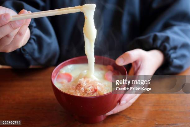 man eating japanese new year's dish called zouni - katsuobushi fotografías e imágenes de stock