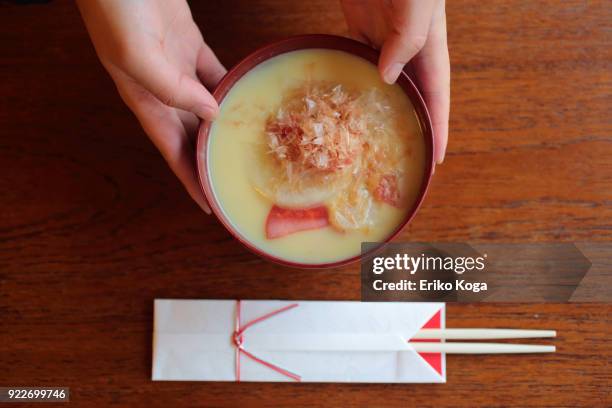 man serving japanese new year's dish called zouni - mizuhiki stock pictures, royalty-free photos & images