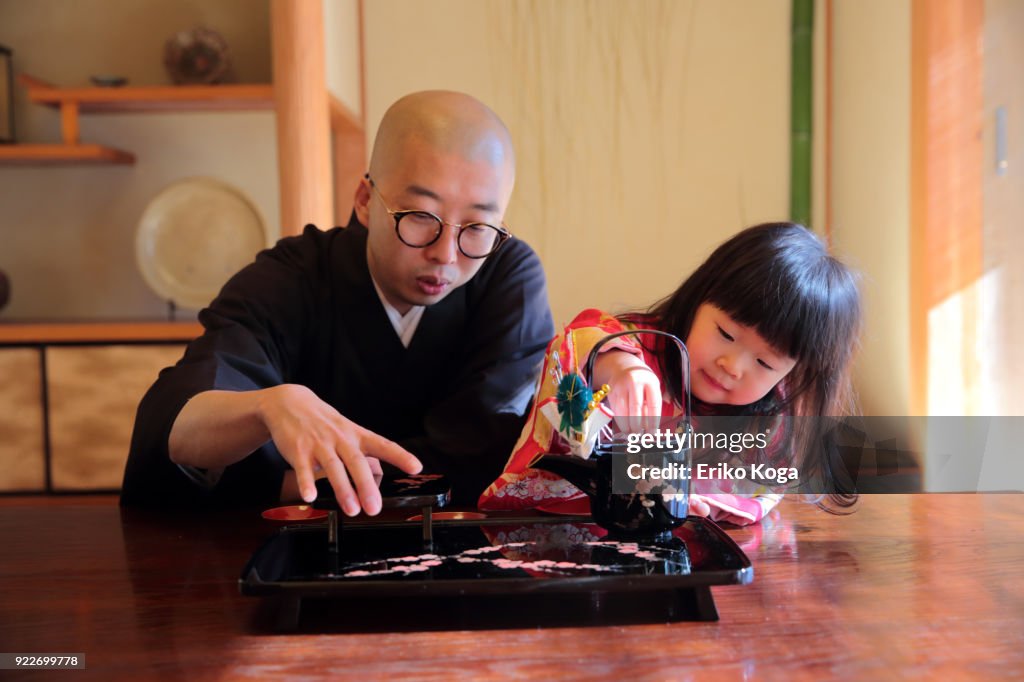 Father and daughter in kimono acting funny