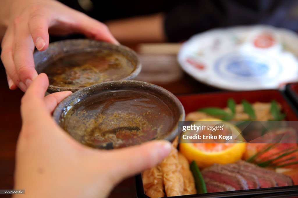 Couple making toast with sake