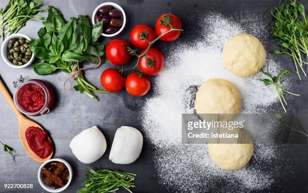 raw pizza dough with ingredients - cooking pan fotografías e imágenes de stock
