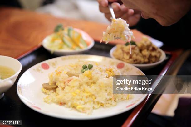 man eating fried rice dish for lunch - teishoku stock pictures, royalty-free photos & images