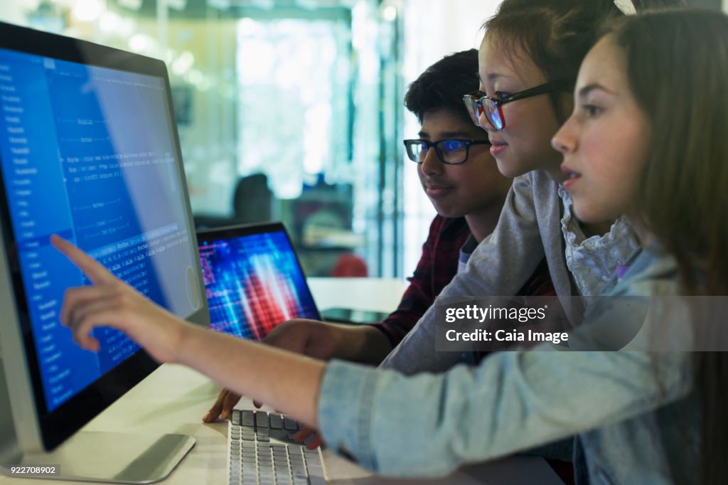 Students programming at computer in computer lab classroom